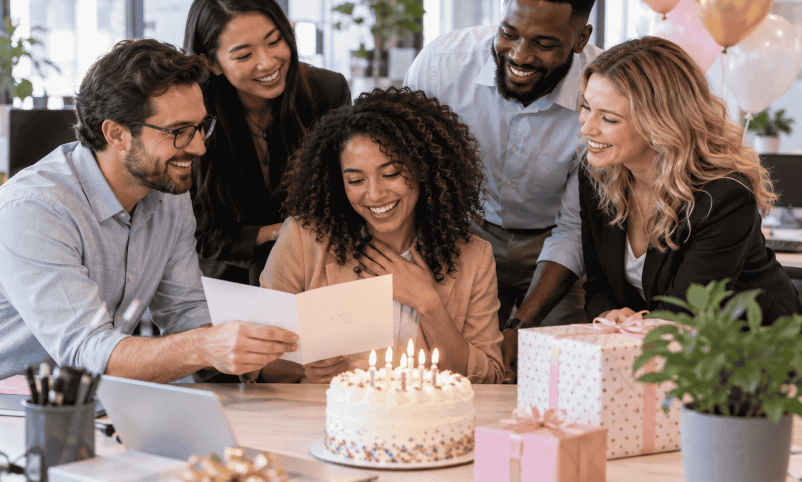group of coworkers celebrating a birthday with cake gifts and birthday messages in modern office